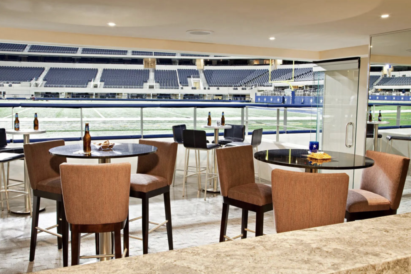 Charles Alan barstools and dining chairs in a suite overlooking the field at Dallas Cowboys Stadium