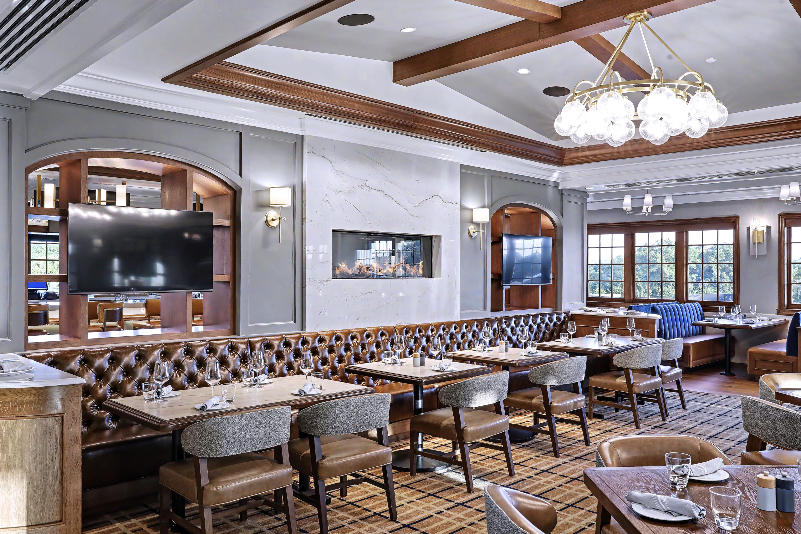 Tufted leather banquettes and dining chairs in the grill room at Colonial Country Club, Fort Worth, TX
